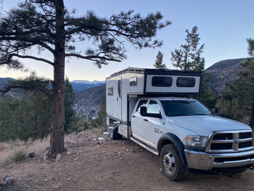 Overland truck camper at mountain campsite 