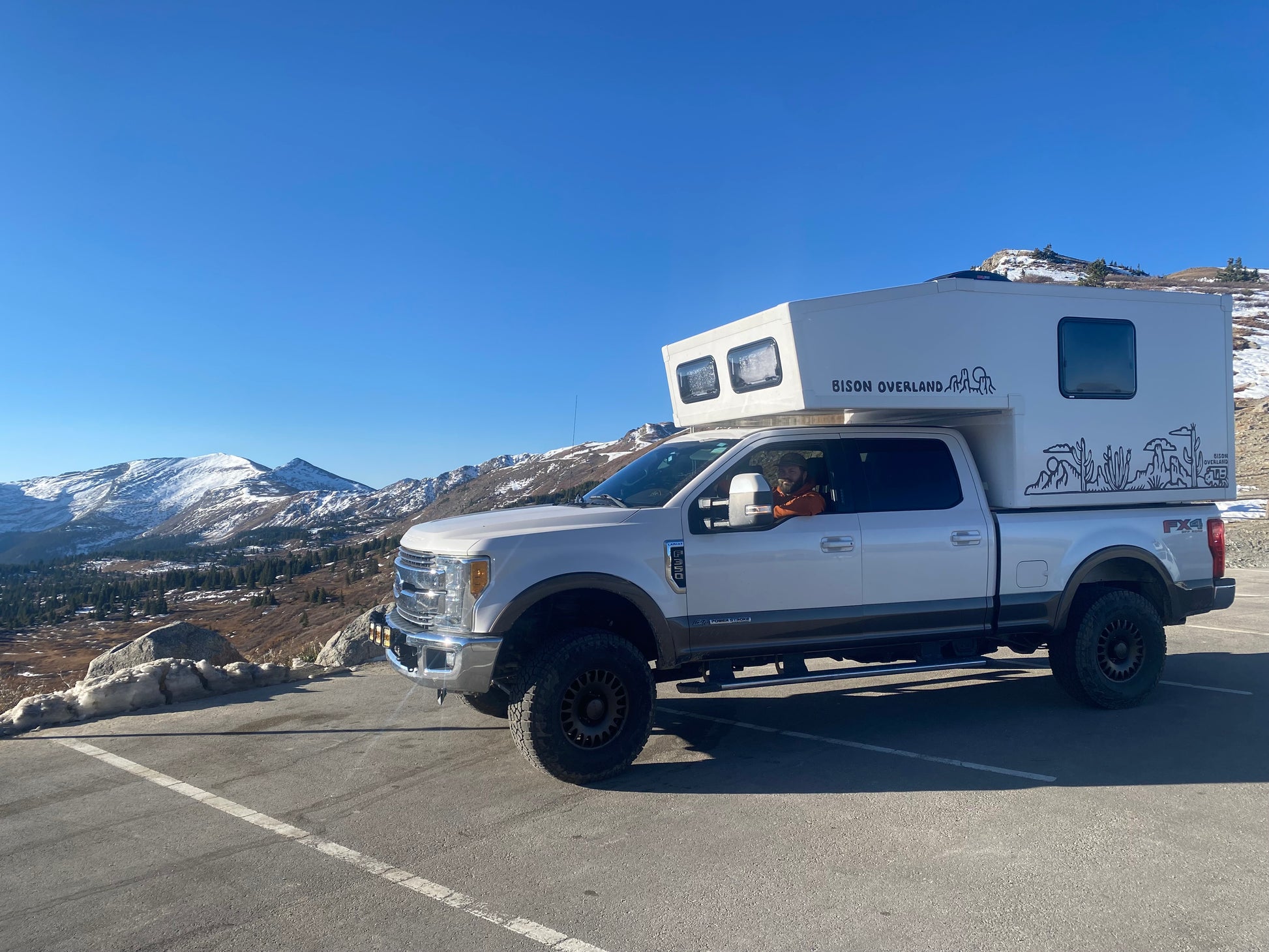 F350 Bison Overland slide in truck camper in the mountains 